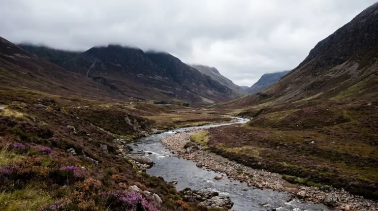 A wide glen with a river running between steep heather covered slopes, Scottish Highlands