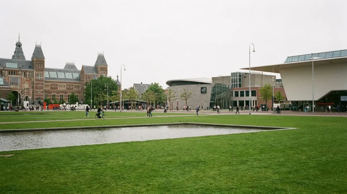 A wide open square with lawns and museum buildings around it, Museumplein, Amsterdam