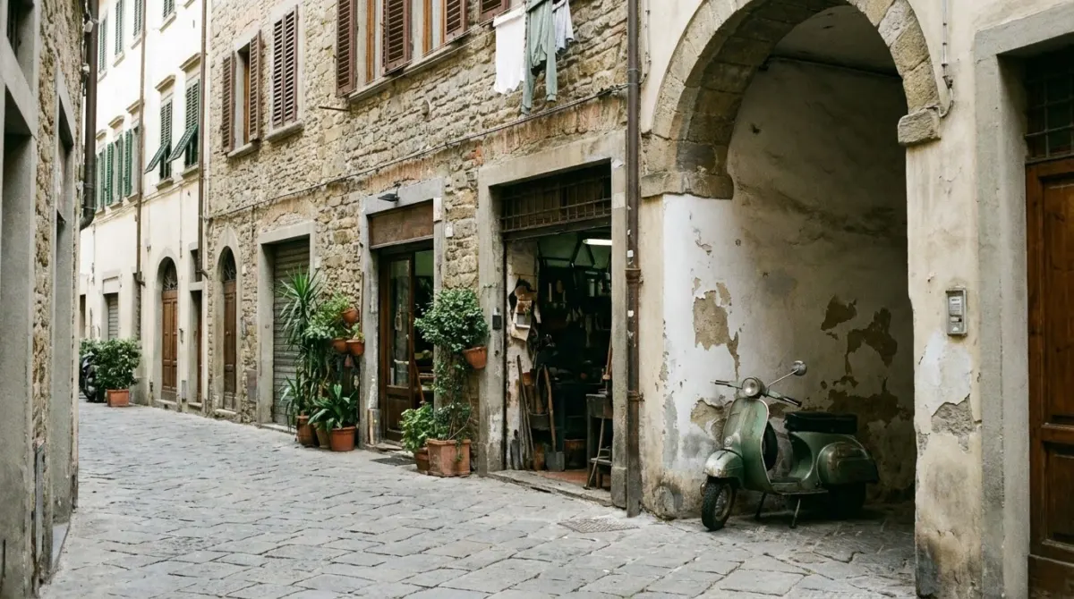 A narrow street of stone buildings with artisan workshops and shuttered windows, Oltrarno, Florence