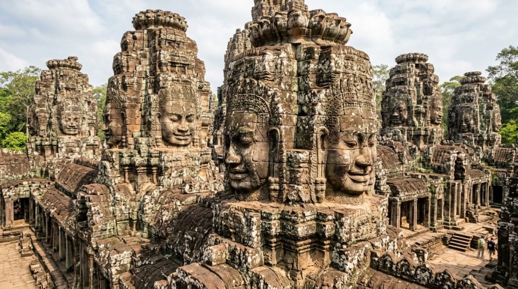 Stone faces carved into the Bayon temple towers at Angkor Thom
