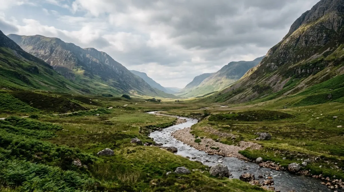A long green Highland glen with a river and mountains under long June daylight, Scottish Highlands