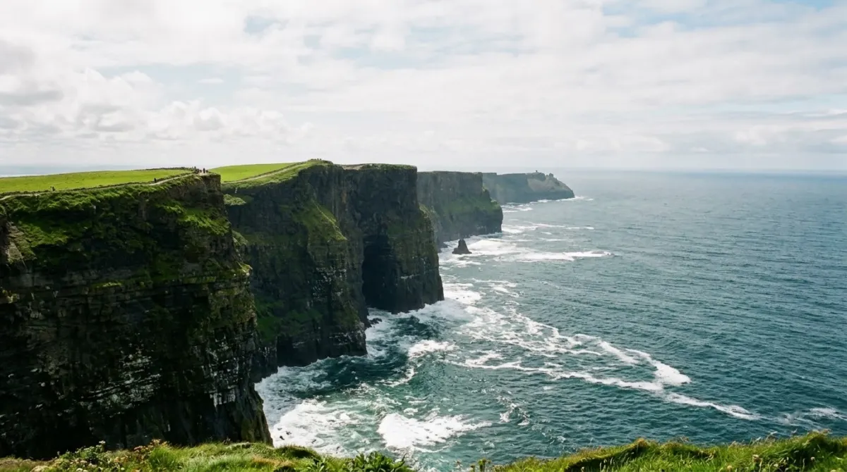High sea cliffs on the Atlantic with waves breaking far below on a bright day, County Clare, Ireland