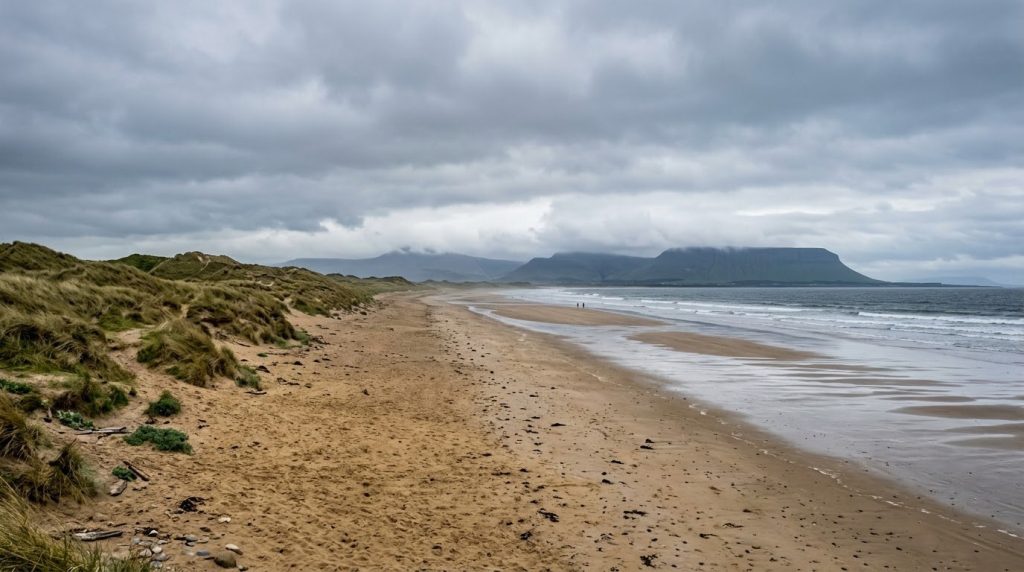 Sandy beach with distant mountains at Rosses Point near Sligo