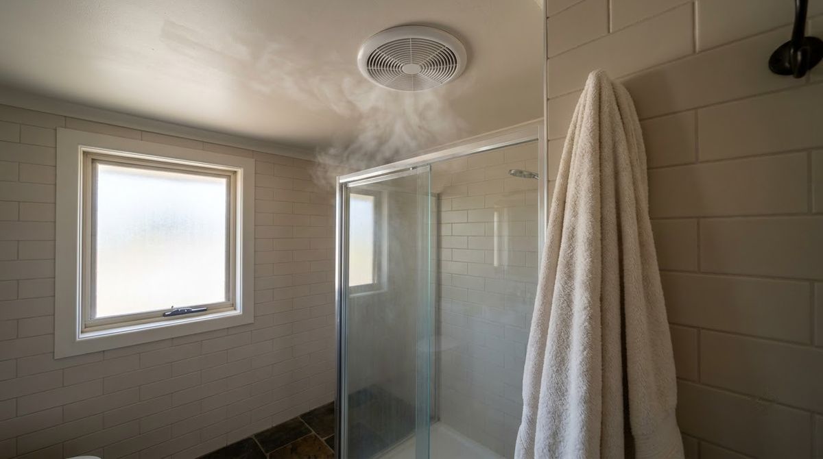 Ceiling exhaust fan above the shower in a small master bathroom